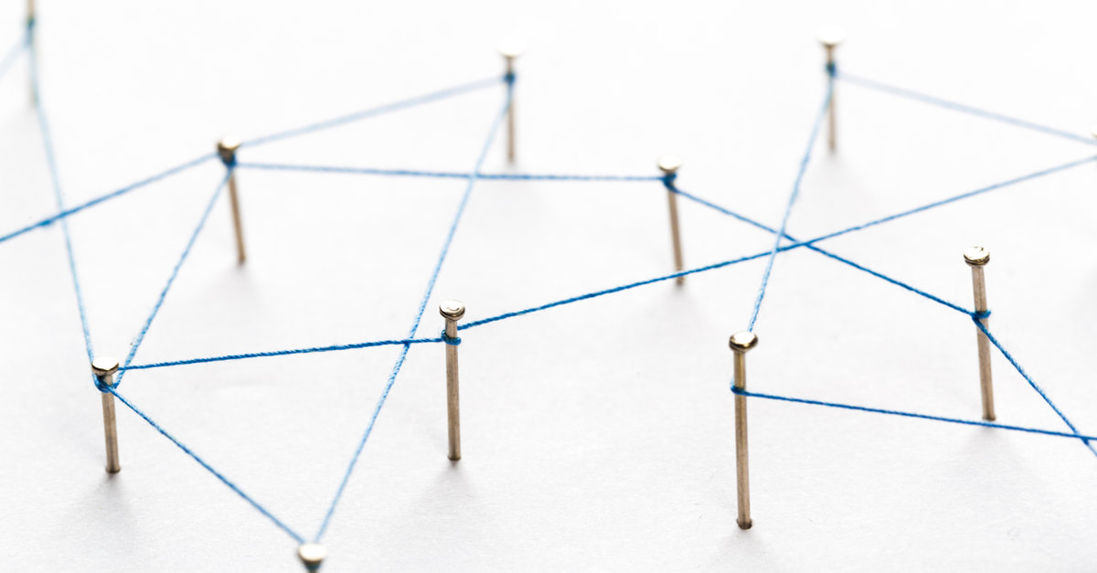 A large grid of pins connected with string. Communication, technology, network concept