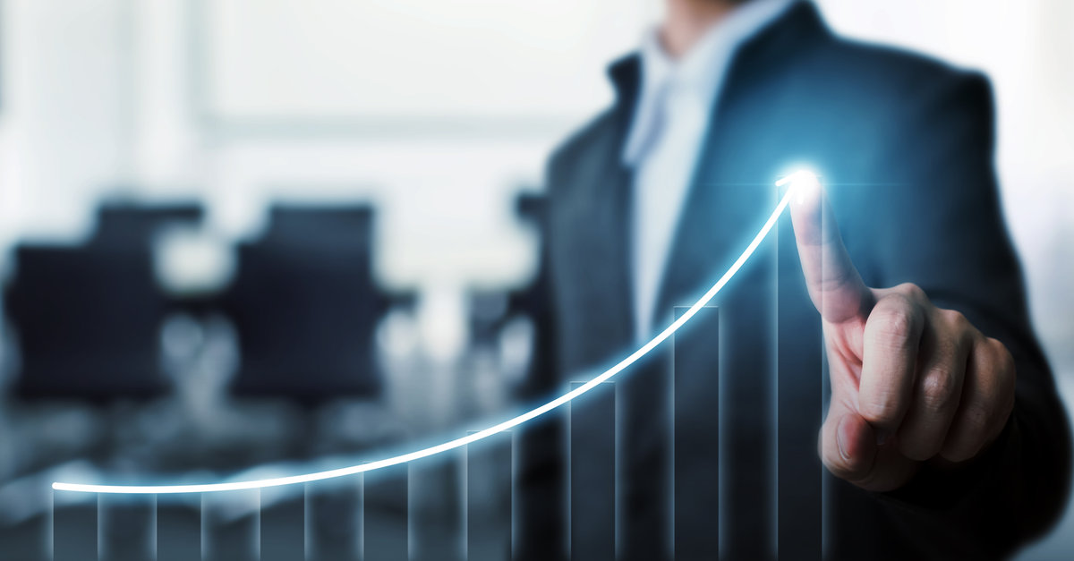 Businessman pointing at arrow graph