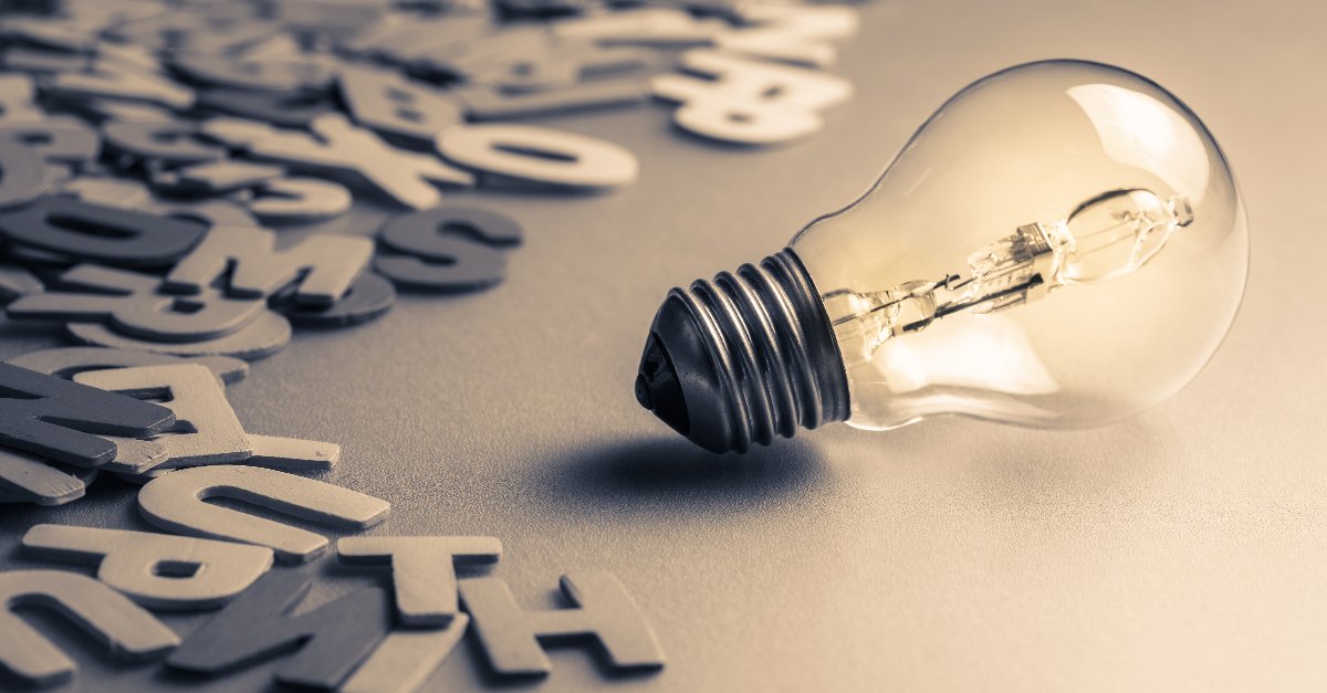 scattered wooden letters and a light blub