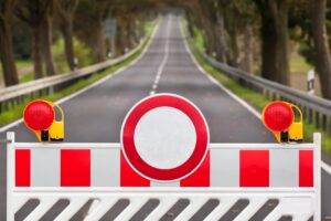 Straight road with a roadblock in front of it 